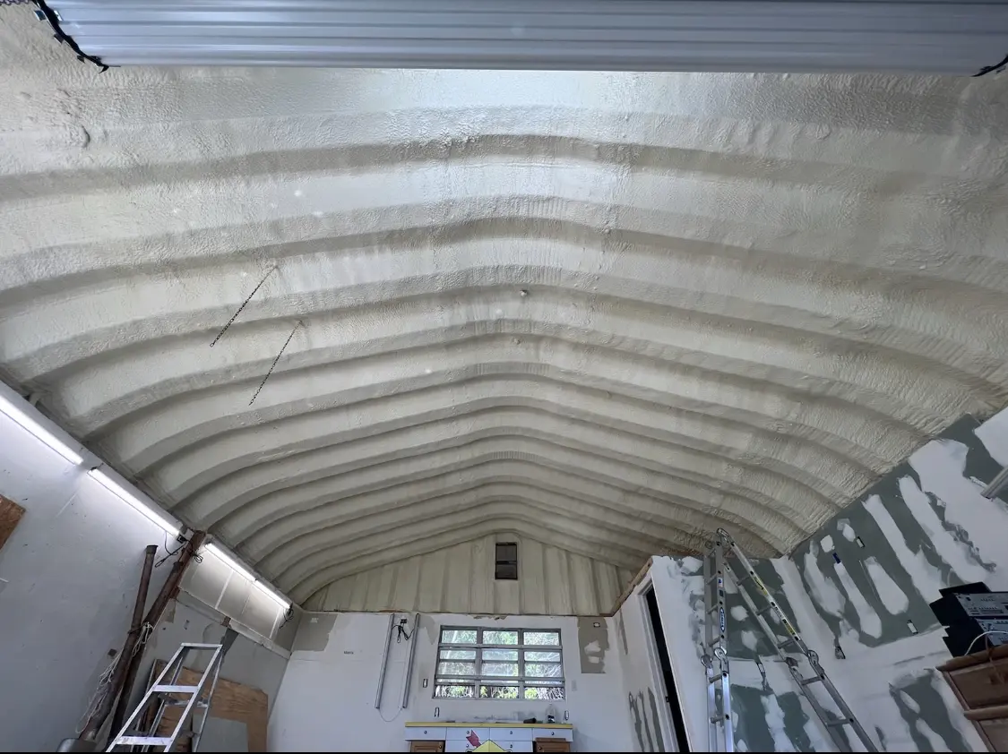 Spray polyurethane foam applied to the underside of a metal roof deck in Mendon